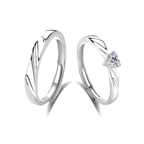 Eternal Flow Couple Ring, matching pair of adjustable open rings, one with a heart-shaped stone, on a white background