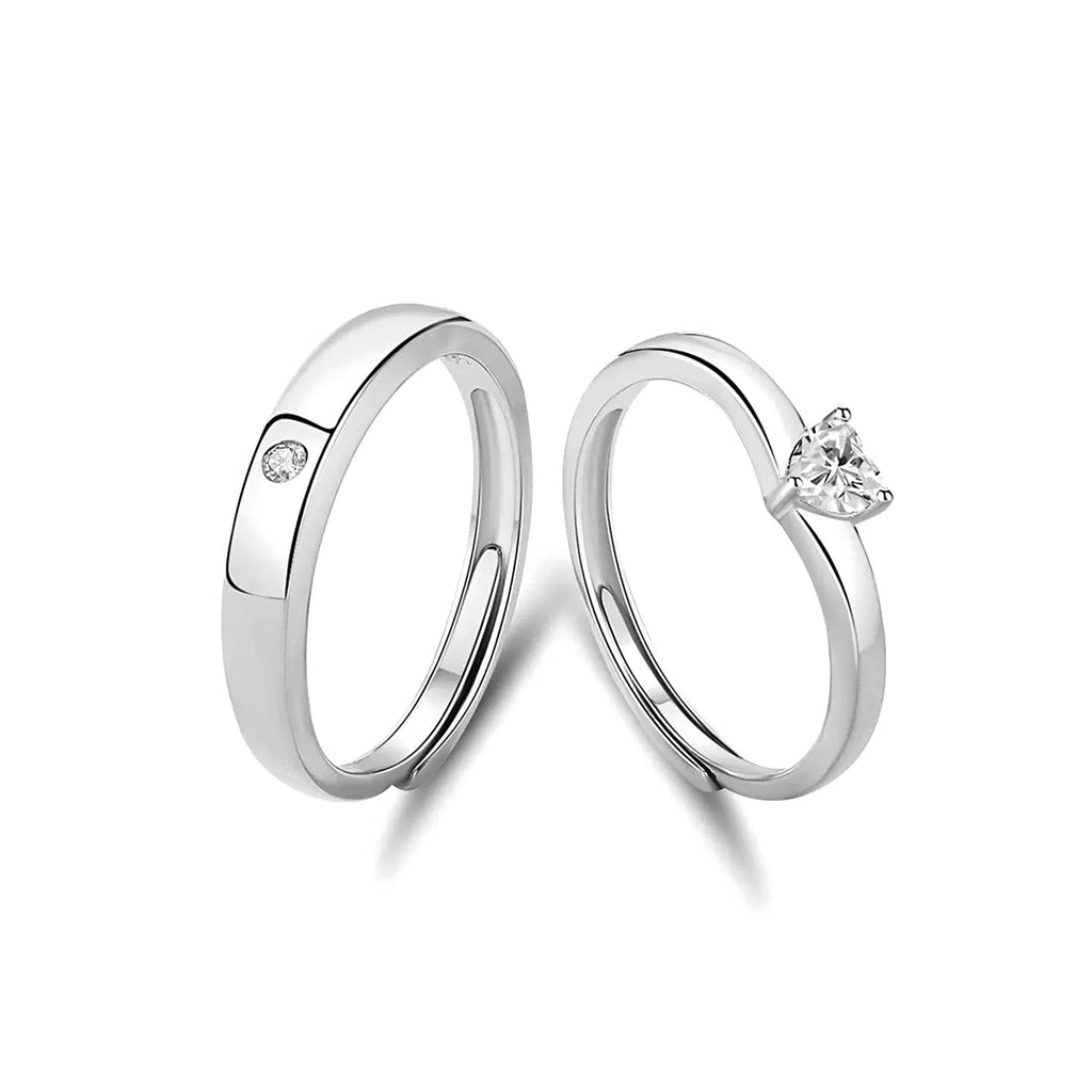 Pure Promise Ring Set, heart-shaped stone ring with a matching polished band set with a small round stone, on a white background