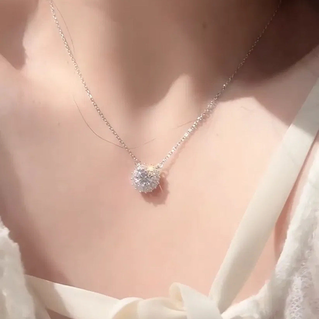 Aurora Halo Moissanite Necklace worn at the collarbone, round moissanite with a baguette-cut halo